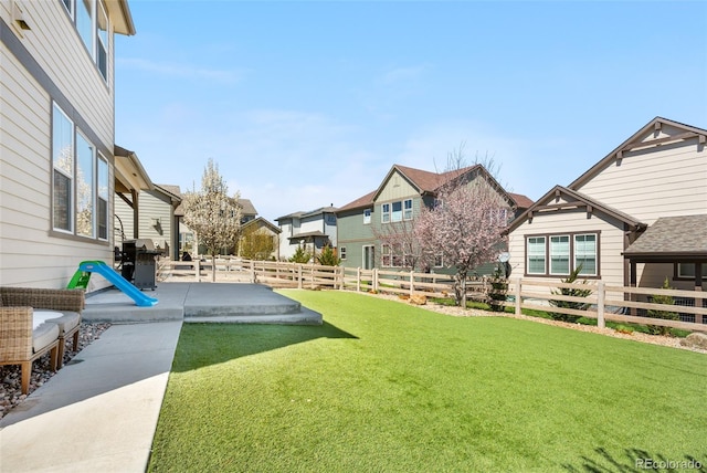 view of yard with a fenced backyard, a patio area, and a residential view