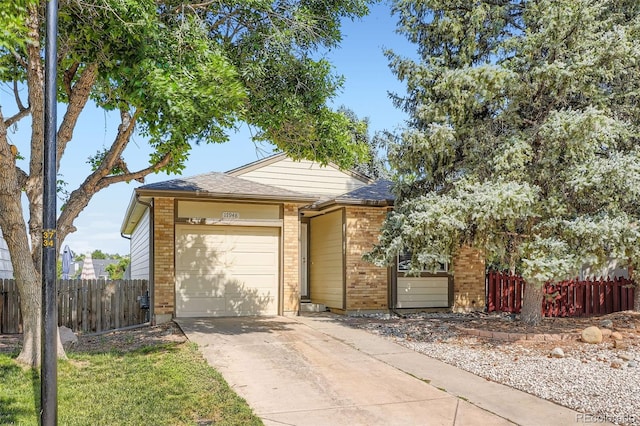 17948 E Colgate Pl, Aurora, CO 80013 - view of front facade featuring brick siding, a garage, and concrete driveway