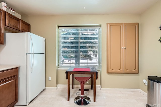 17948 E Colgate Pl, Aurora, CO 80013 - kitchen featuring freestanding refrigerator, plenty of natural light, and light countertops