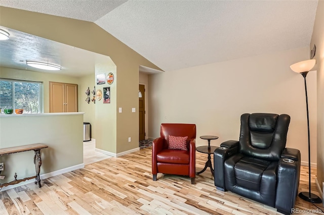 17948 E Colgate Pl, Aurora, CO 80013 - living area featuring lofted ceiling, light wood-style floors, and a textured ceiling