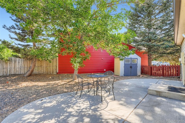17948 E Colgate Pl, Aurora, CO 80013 - fenced backyard with a patio area, outdoor dining space, and a storage shed