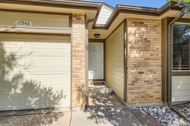 17948 E Colgate Pl, Aurora, CO 80013 - doorway to property with brick siding and a garage