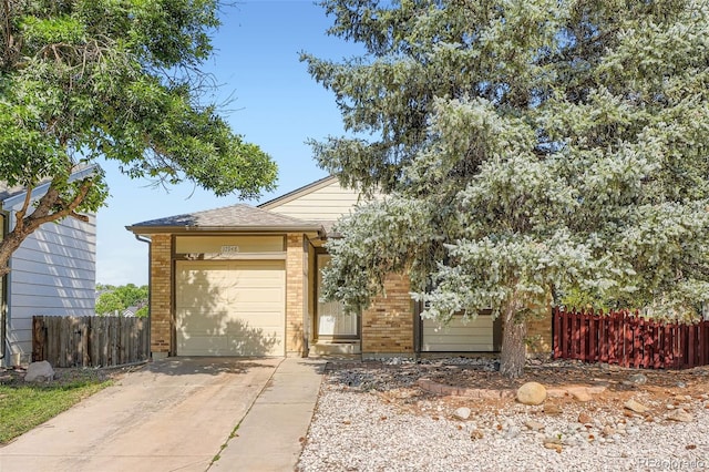 17948 E Colgate Pl, Aurora, CO 80013 - obstructed view of property with brick siding, driveway, and an attached garage