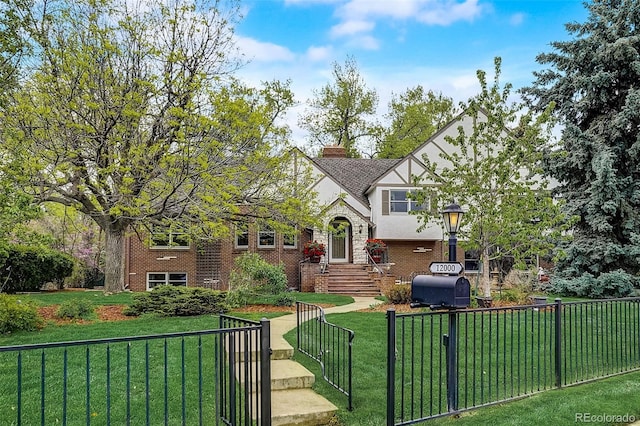 tudor-style house with a front yard