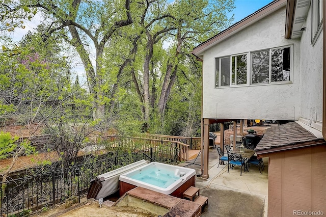 exterior space with a hot tub