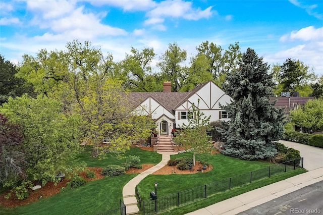 english style home featuring a front lawn