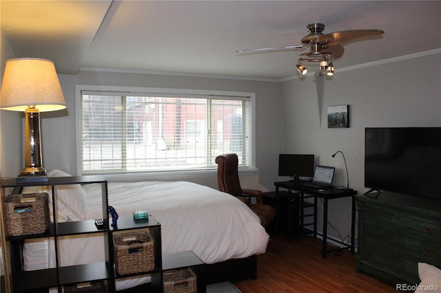 bedroom featuring ornamental molding and wood finished floors