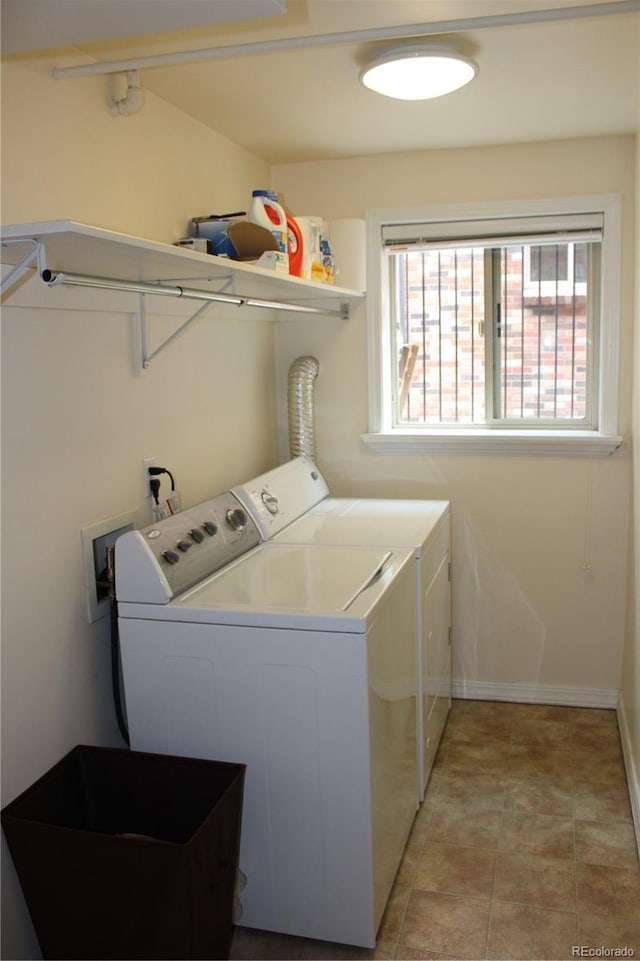 laundry area featuring independent washer and dryer, laundry area, baseboards, and a healthy amount of sunlight