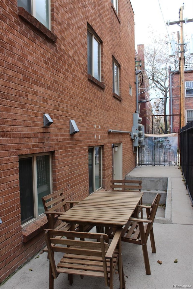 view of patio featuring fence and outdoor dining area