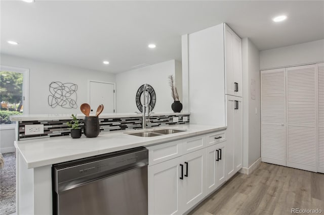 7970 Chase Cir Unit 85, Arvada, CO 80003 - kitchen featuring stainless steel dishwasher, light wood finished floors, backsplash, white cabinetry, and recessed lighting