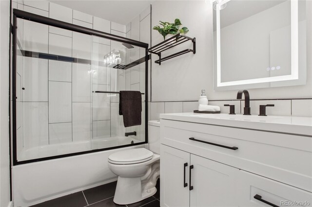 7970 Chase Cir Unit 85, Arvada, CO 80003 - bathroom featuring vanity, combined bath / shower with glass door, and tile patterned flooring