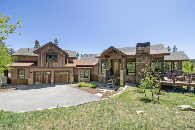 41 Barton Ridge Dr, Breckenridge, CO 80424 - view of front facade with stone siding, asphalt driveway, an attached garage, a front lawn, and roof with shingles
