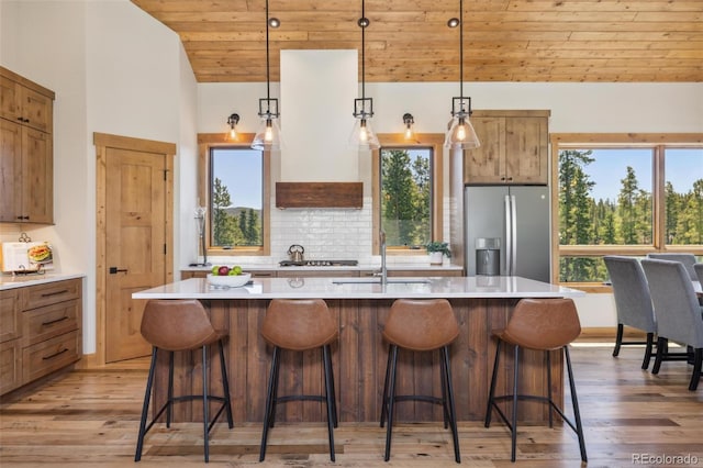 41 Barton Ridge Dr, Breckenridge, CO 80424 - kitchen with stainless steel fridge with ice dispenser, wood ceiling, light wood-type flooring, plenty of natural light, and lofted ceiling