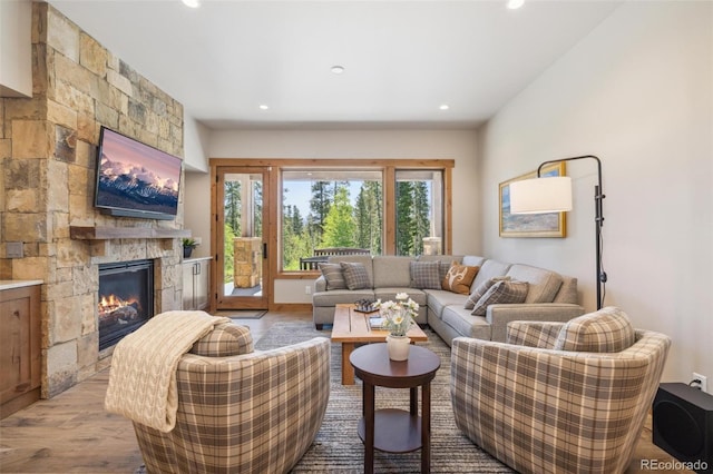 41 Barton Ridge Dr, Breckenridge, CO 80424 - living room with wood finished floors, a stone fireplace, and recessed lighting