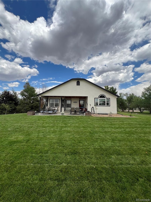 825 Cherokee St, Strasburg, CO 80136 - rear view of property featuring a patio area and a lawn
