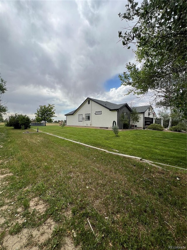 825 Cherokee St, Strasburg, CO 80136 - view of side of property featuring a lawn