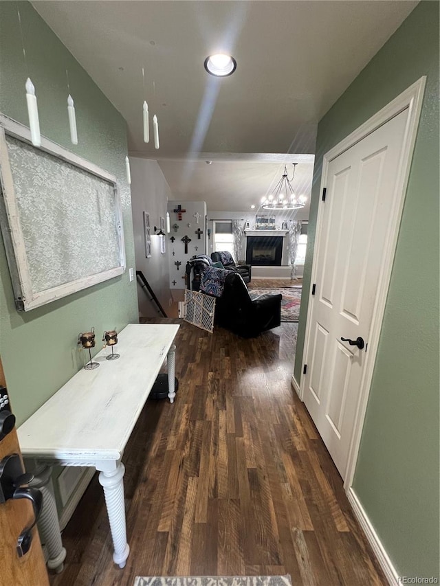 825 Cherokee St, Strasburg, CO 80136 - hallway with dark wood-type flooring and a chandelier