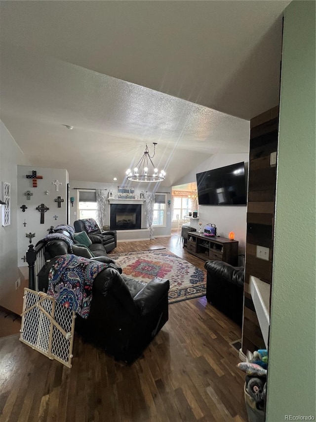 825 Cherokee St, Strasburg, CO 80136 - living area with wood finished floors, a chandelier, and lofted ceiling