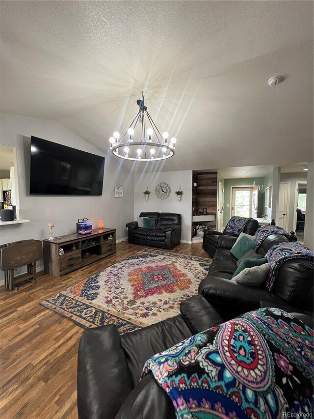 825 Cherokee St, Strasburg, CO 80136 - living room with a chandelier, a textured ceiling, wood finished floors, and lofted ceiling