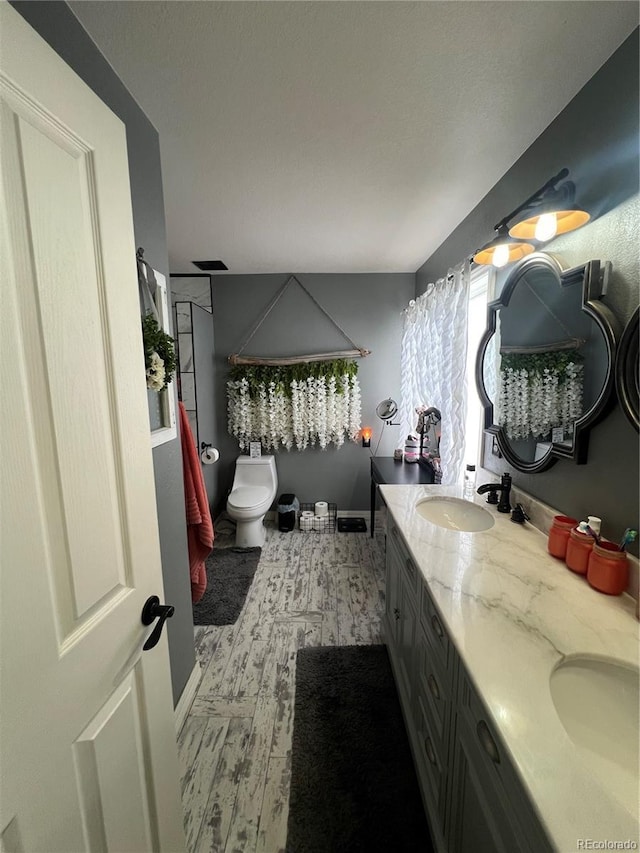 825 Cherokee St, Strasburg, CO 80136 - bathroom with wood finished floors and double vanity