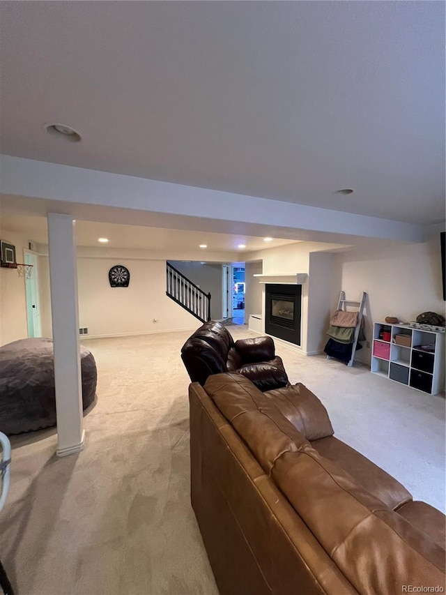 825 Cherokee St, Strasburg, CO 80136 - carpeted living room with recessed lighting, a glass covered fireplace, and stairway
