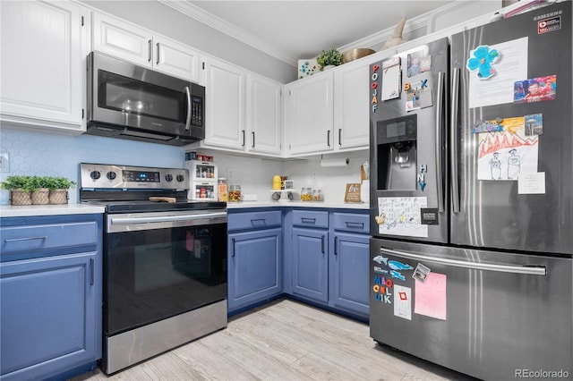 kitchen featuring ornamental molding, stainless steel appliances, white cabinetry, and light wood-type flooring