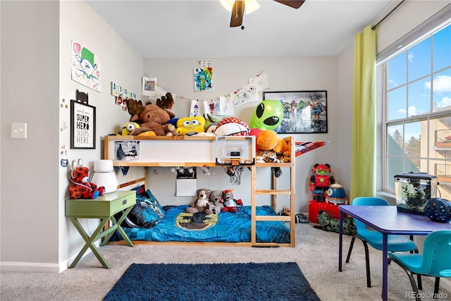 carpeted bedroom with multiple windows and ceiling fan