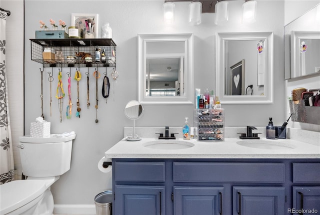 bathroom featuring vanity and toilet