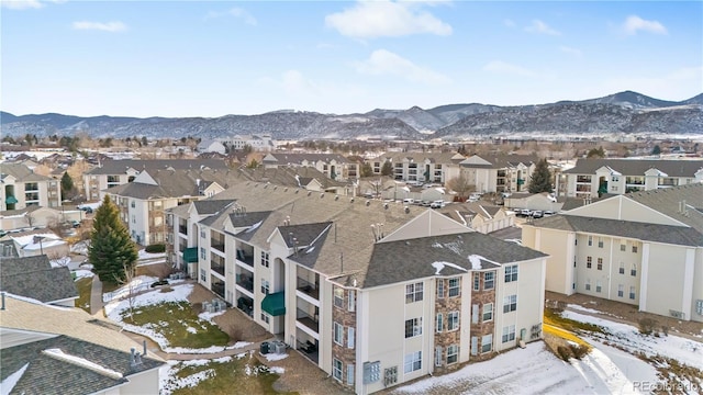 snowy aerial view with a mountain view