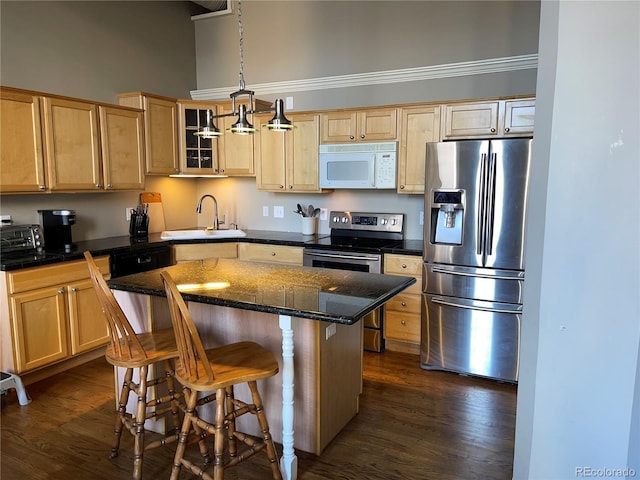 1555 California St Unit 302, Denver, CO 80202 - kitchen with appliances with stainless steel finishes, light brown cabinets, a center island, dark wood-type flooring, and a high ceiling