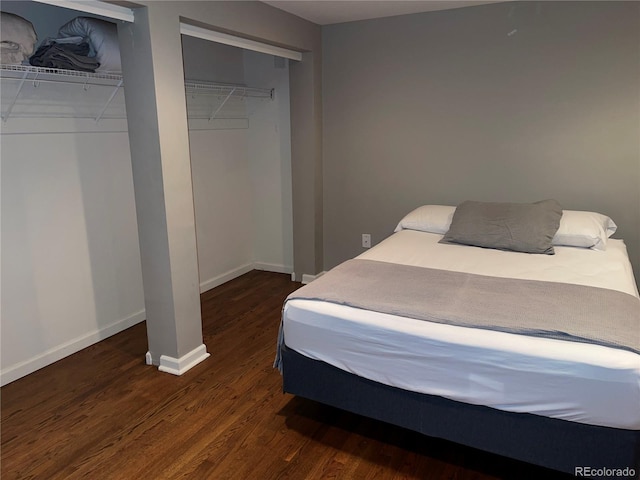 1555 California St Unit 302, Denver, CO 80202 - bedroom featuring dark wood-type flooring and multiple closets