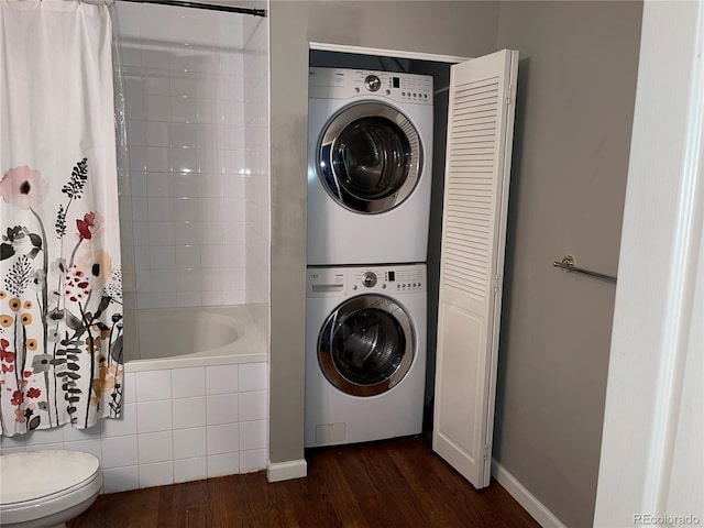 1555 California St Unit 302, Denver, CO 80202 - laundry area featuring stacked washer / dryer and dark wood-type flooring