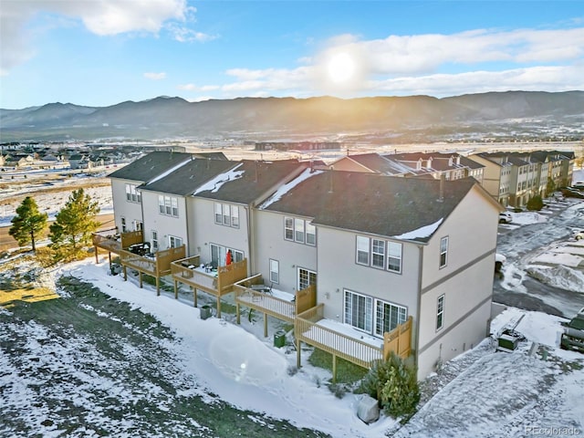 snowy aerial view with a mountain view