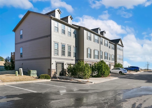 exterior space with uncovered parking and a residential view