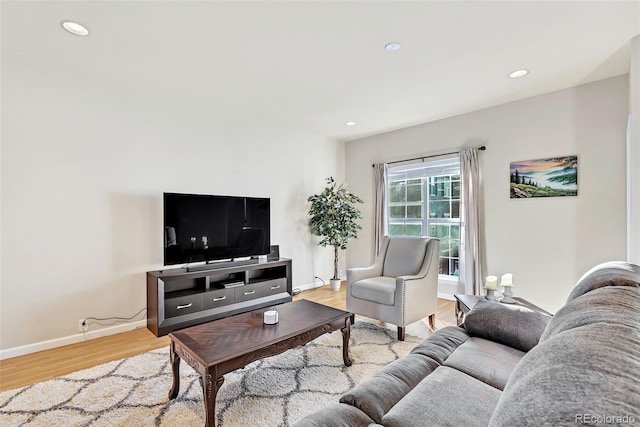 living room with recessed lighting, light wood-style flooring, and baseboards