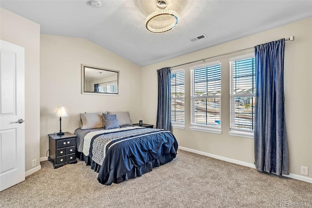 carpeted bedroom featuring lofted ceiling, visible vents, and baseboards