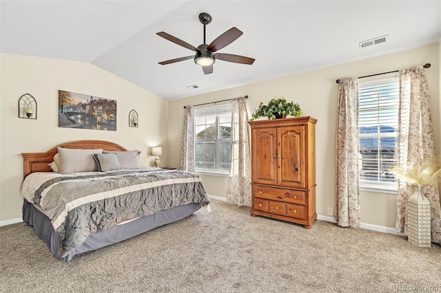 bedroom with vaulted ceiling, multiple windows, light carpet, and visible vents