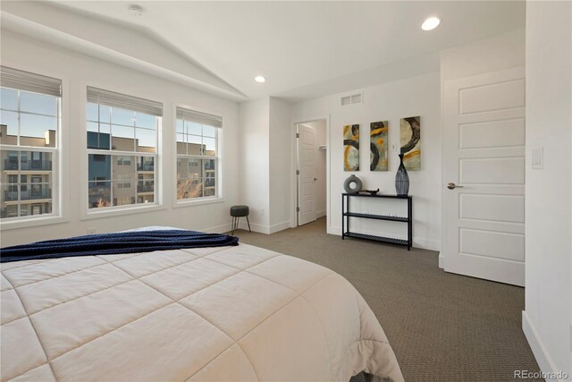 carpeted bedroom featuring lofted ceiling