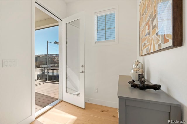 doorway with french doors and light hardwood / wood-style floors