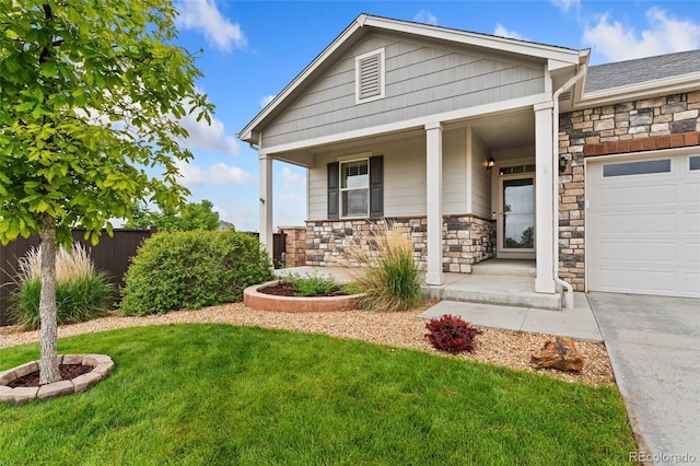 15525 Quince Cir, Thornton, CO 80602 - view of front facade featuring a porch, stone siding, and an attached garage