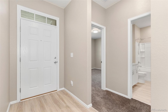 15525 Quince Cir, Thornton, CO 80602 - entryway with baseboards, light colored carpet, and light wood finished floors