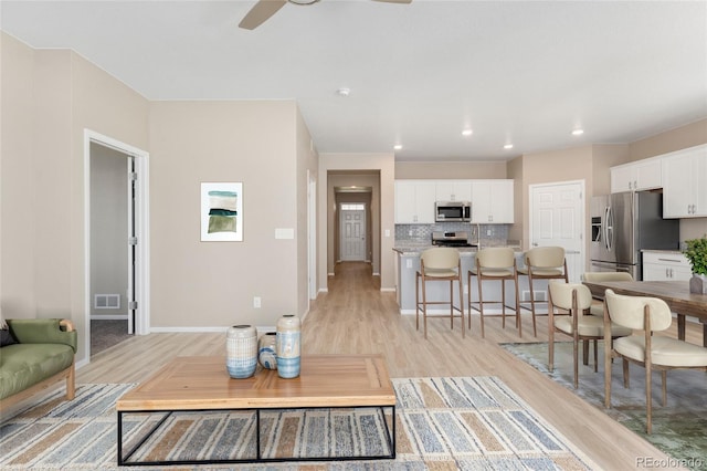 15525 Quince Cir, Thornton, CO 80602 - living area featuring light wood-style flooring, a ceiling fan, baseboards, and recessed lighting