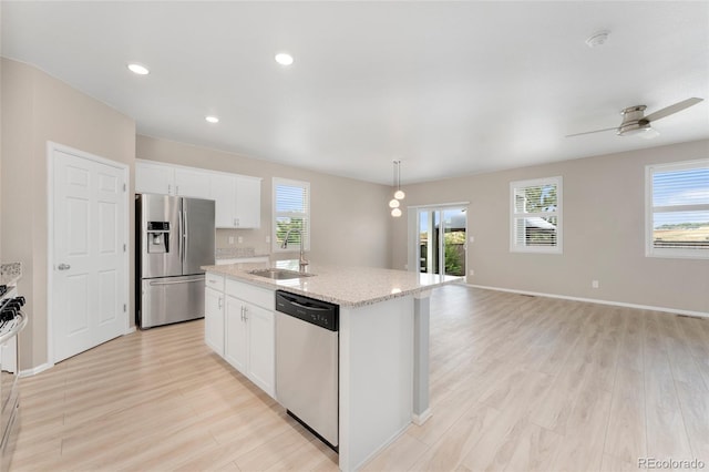 15525 Quince Cir, Thornton, CO 80602 - kitchen with stainless steel appliances, a sink, healthy amount of natural light, light wood-type flooring, and recessed lighting