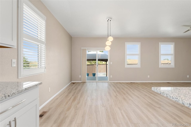 15525 Quince Cir, Thornton, CO 80602 - unfurnished dining area featuring light wood-style flooring, baseboards, and a ceiling fan
