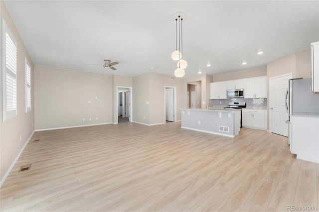 15525 Quince Cir, Thornton, CO 80602 - unfurnished living room featuring ceiling fan, baseboards, light wood-type flooring, and recessed lighting