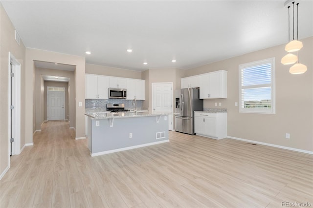 15525 Quince Cir, Thornton, CO 80602 - kitchen featuring appliances with stainless steel finishes, light wood finished floors, baseboards, a sink, and white cabinets