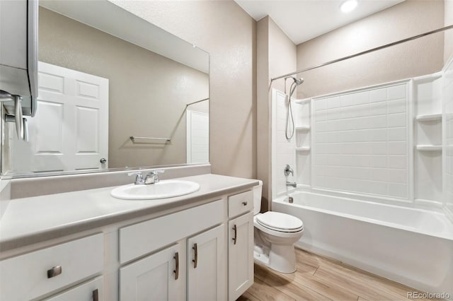 15525 Quince Cir, Thornton, CO 80602 - bathroom with wood finished floors, toilet, vanity, bathing tub / shower combination, and a textured wall