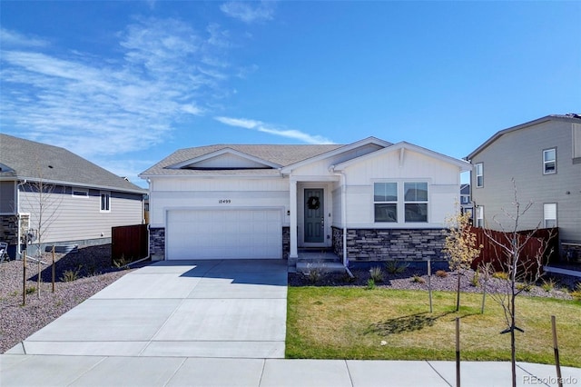 10499 Rolling Peaks Dr, Peyton, CO 80831 - view of front of property with stone siding, a garage, concrete driveway, and board and batten siding