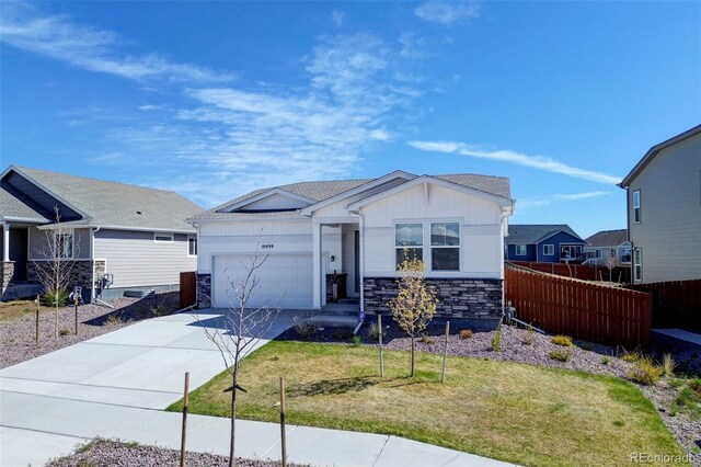 10499 Rolling Peaks Dr, Peyton, CO 80831 - view of front facade with a garage, stone siding, concrete driveway, and board and batten siding