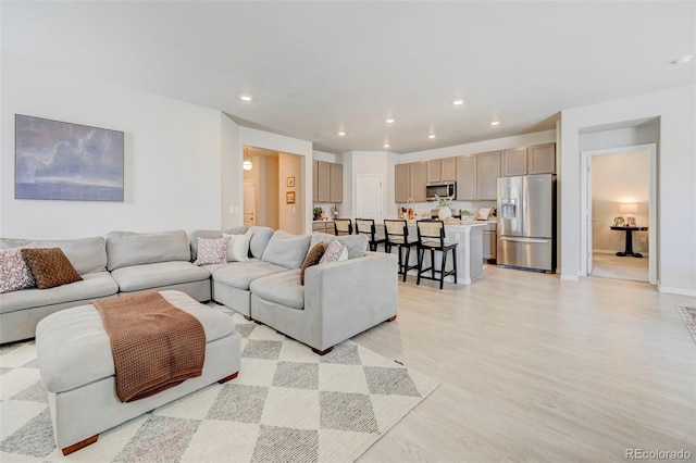 10499 Rolling Peaks Dr, Peyton, CO 80831 - living area with light wood finished floors, recessed lighting, and baseboards